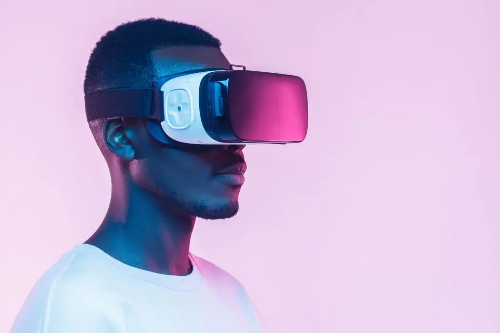 VR concept. Young african man wearing virtual reality goggles