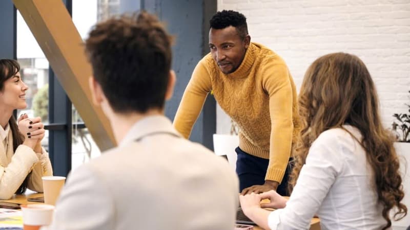 Black male team leader at business meeting