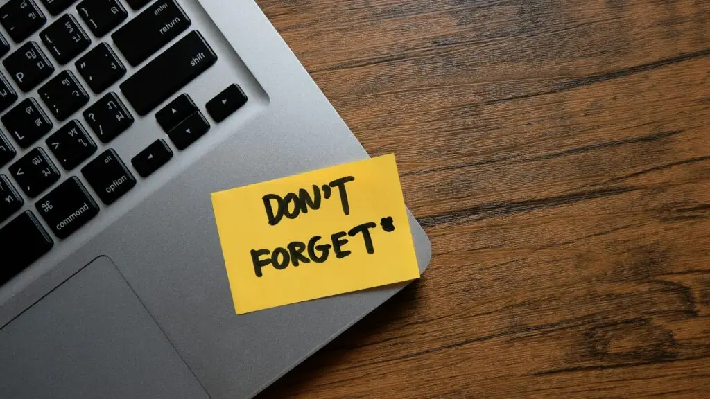 Don't forget message concept written post it on laptop keyboard