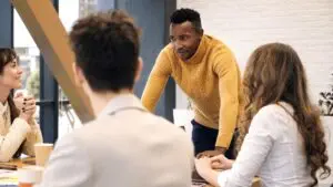 Black male team leader at business meeting